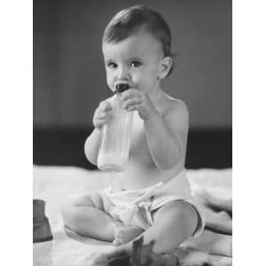  Baby Girl (12 18 Months) Sitting on Bed, Holding Bottle 