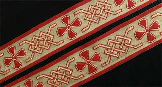   motif is jacquard woven in red and metallic gold on this wide trim