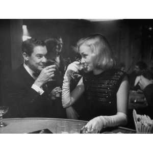 Nina Foch and Dress Designer Jean Louis Sipping Champagne at Samuel 